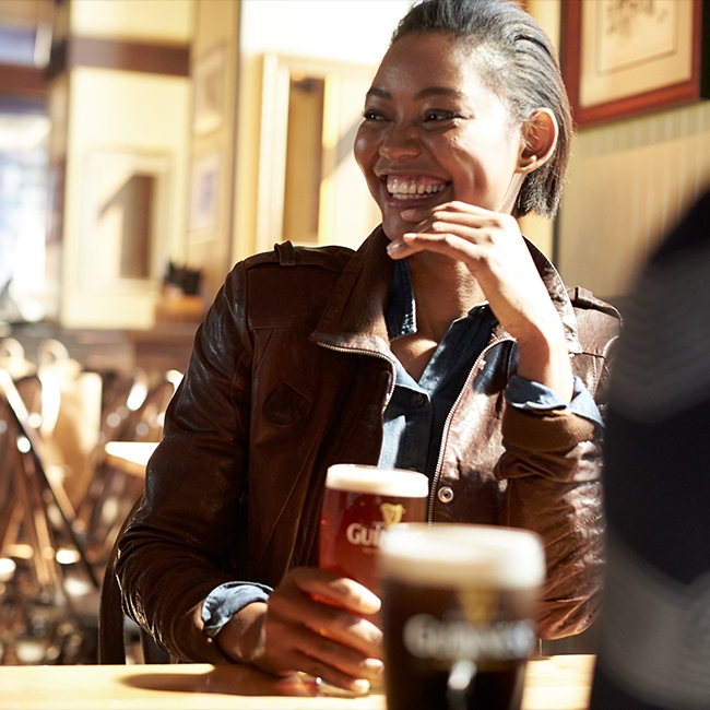 Woman Smiling With A Glass Of Guinness